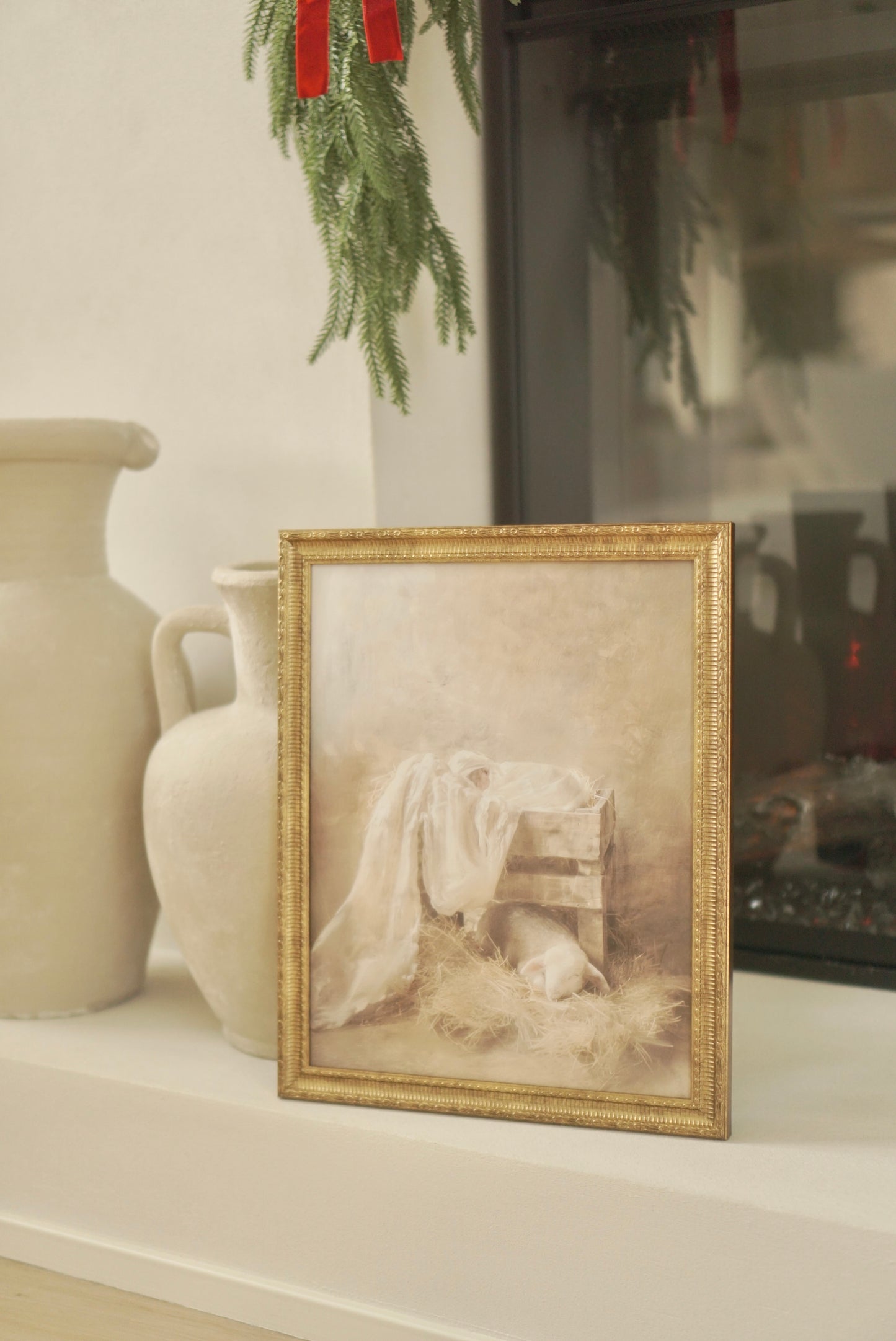 Framed artwork on a mantelpiece with decorative elements. Christian Christmas artwork made by a christian artist. Nativity scene artwork.