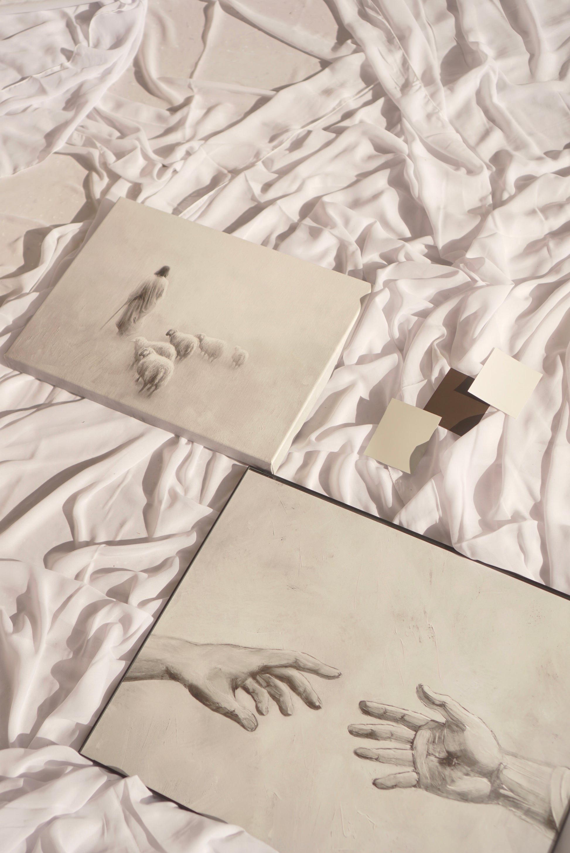 Two drawings of hands reaching towards each other on a textured white surface. Gentle Shepherd B&W Canvas Christian wall art modern, Jesus the Shepherd, devotion-inspired.