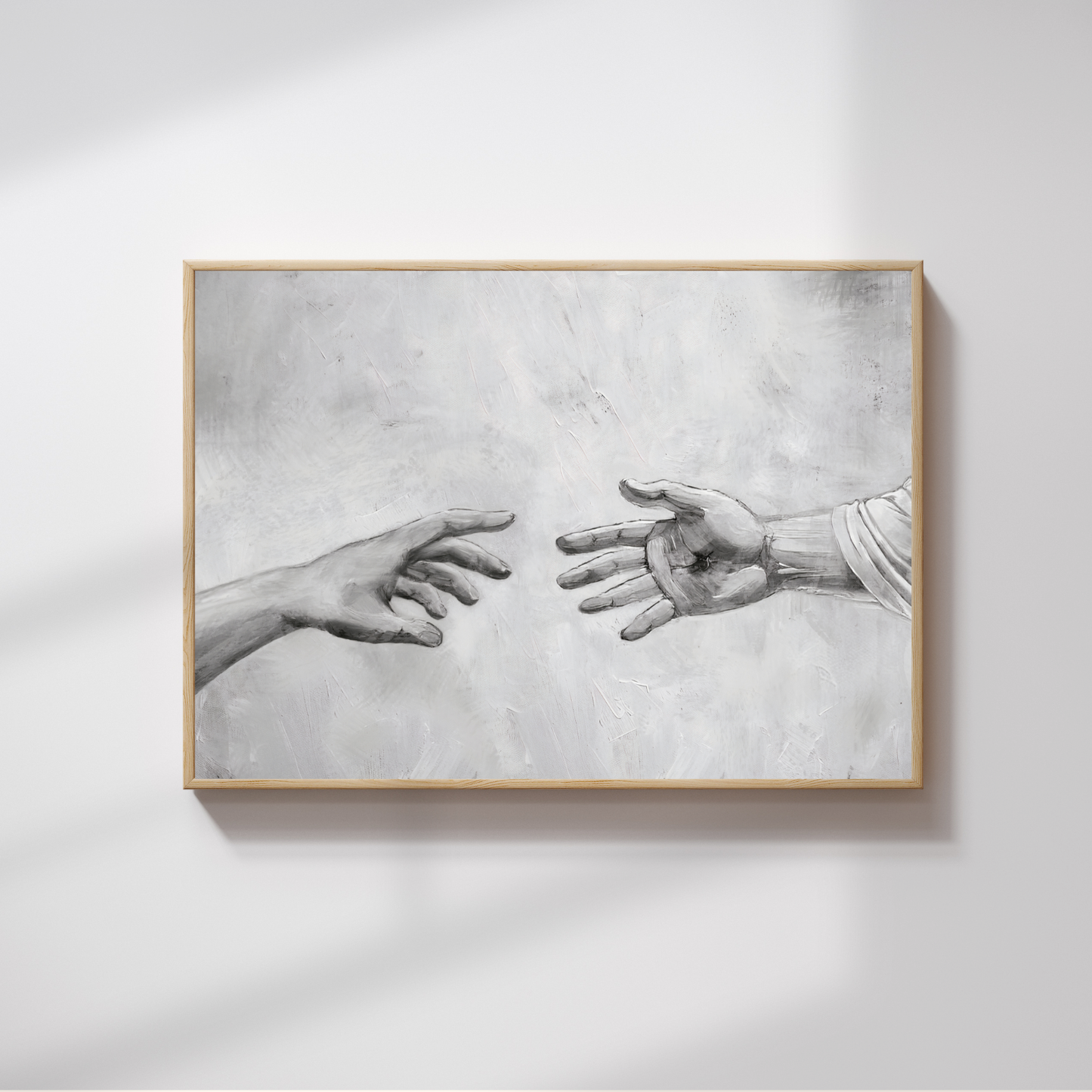 Framed artwork of two hands reaching towards each other on a light gray background. Reaching Out Canvas modern Christian wall art showing Jesus’ healing, by Christian artist.