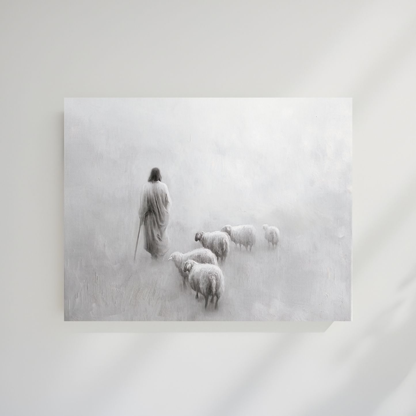 Framed black and white artwork of a shepherd with sheep in a snowy landscape. Gentle Shepherd B&W Christian art modern, Jesus’ compassion, black and white wall print.