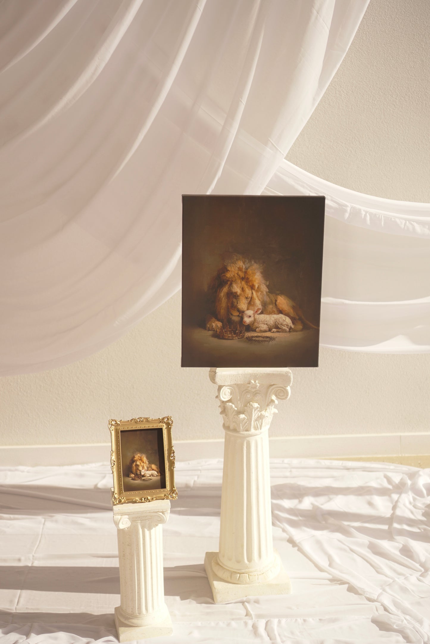 Framed artwork of a lion on a pedestal against a draped white wall. Lion and The Lamb Canvas modern Christian wall art by Christian artist depicting Christ’s power.